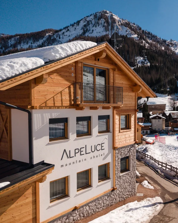 The story of our chalet in Arabba Alpelucé mountain chalet overlooking snowy ski slopes and mountains