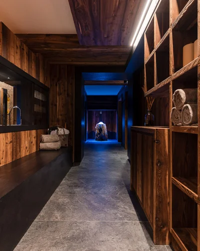 Indoor hallway with wooden shelves and rolled towels